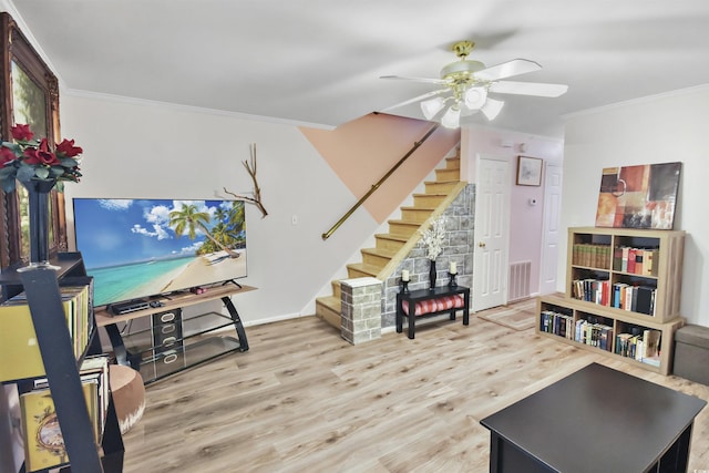 interior space featuring light hardwood / wood-style floors, ceiling fan, and ornamental molding