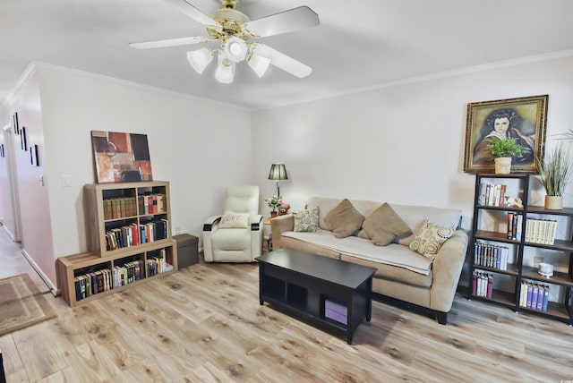 living room with light hardwood / wood-style floors, crown molding, and ceiling fan