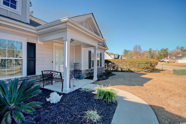 view of side of property featuring a porch