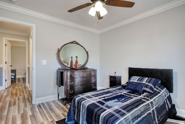 bedroom featuring ceiling fan, ornamental molding, and light wood-type flooring