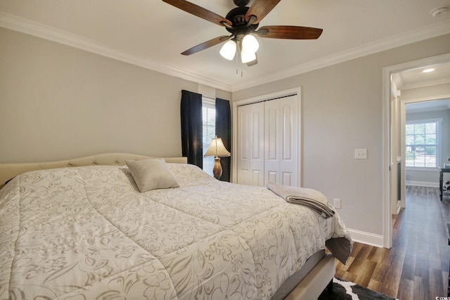 bedroom with ceiling fan, multiple windows, a closet, and crown molding