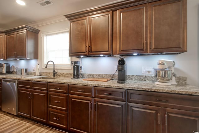 kitchen featuring light stone countertops, dishwasher, light wood-type flooring, sink, and ornamental molding