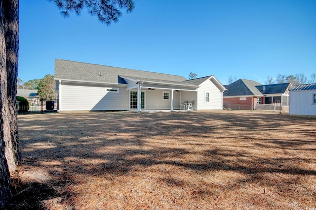 back of property featuring a lawn