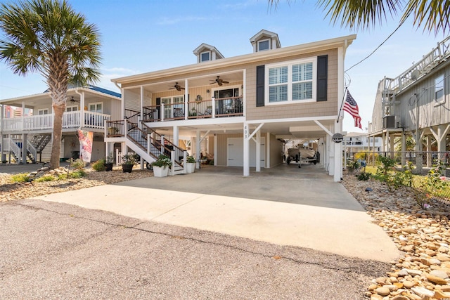 view of front of property featuring ceiling fan, a porch, and a carport