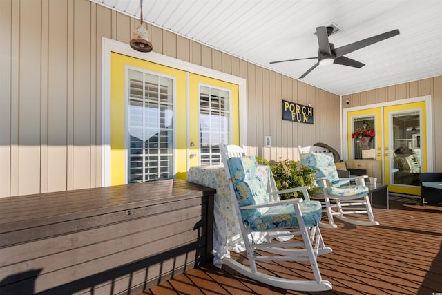 deck with covered porch, ceiling fan, and french doors