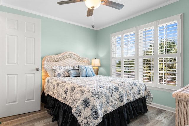 bedroom featuring ceiling fan, hardwood / wood-style floors, and ornamental molding