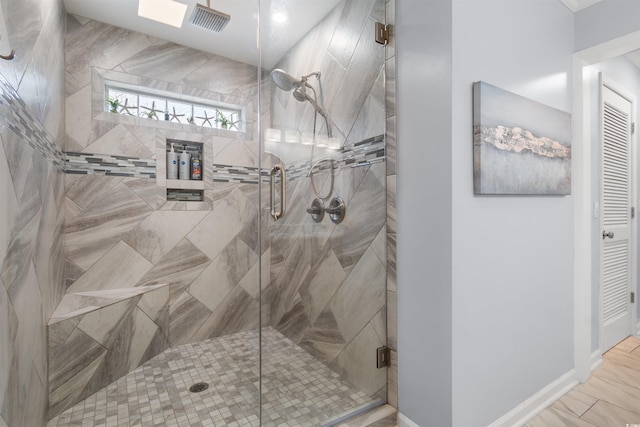 bathroom featuring a shower with door