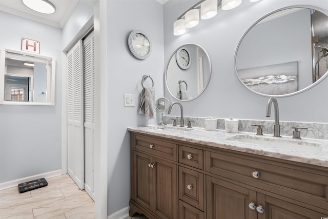 bathroom featuring crown molding and vanity