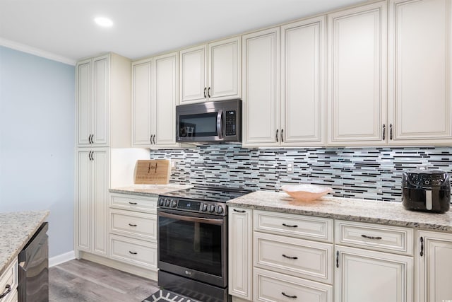 kitchen featuring light stone countertops, appliances with stainless steel finishes, and decorative backsplash