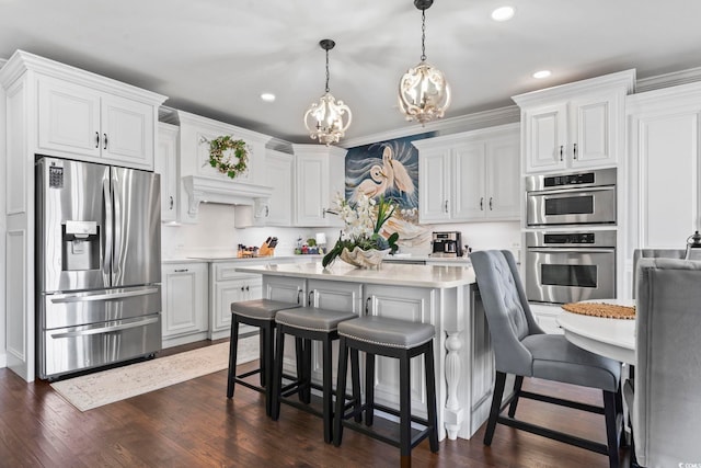 kitchen featuring pendant lighting, white cabinetry, dark hardwood / wood-style flooring, and stainless steel appliances