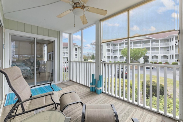 sunroom with ceiling fan and a wealth of natural light