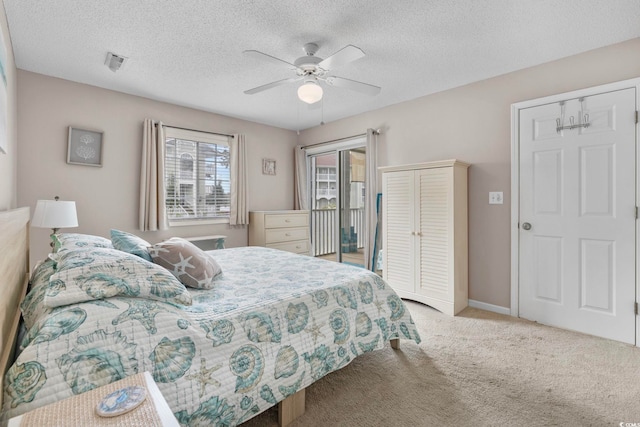 bedroom featuring ceiling fan, a textured ceiling, access to outside, and light carpet