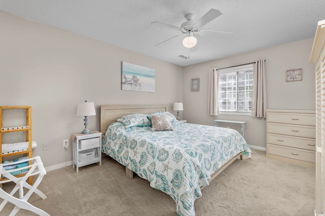 bedroom with light carpet, a textured ceiling, and ceiling fan