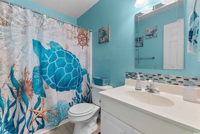 bathroom with hardwood / wood-style floors, a textured ceiling, toilet, vanity, and decorative backsplash