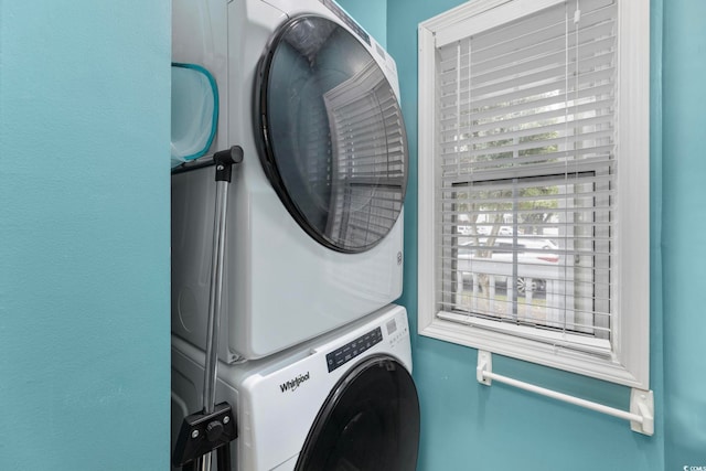 laundry room featuring stacked washer / drying machine