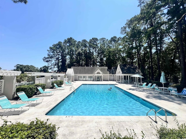 view of swimming pool featuring a patio area