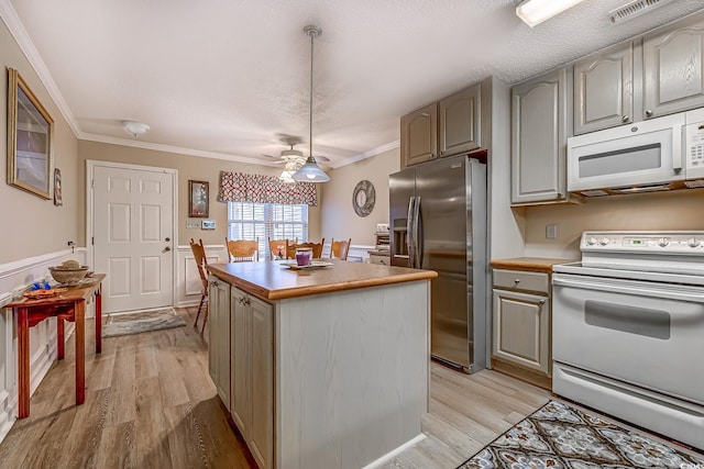 880 Fairway Dr Unit 302Bb, Longs, SC 29568 - kitchen with white appliances, a kitchen island, ornamental molding, light countertops, and light wood-type flooring