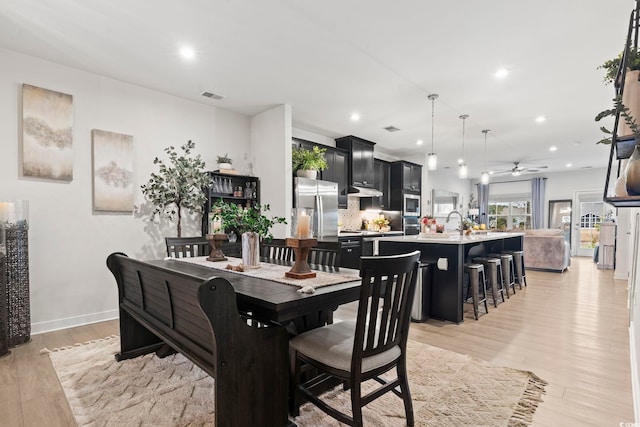 dining space featuring light hardwood / wood-style floors and ceiling fan