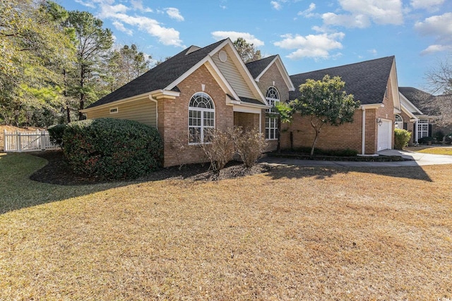 view of front of house with a garage and a front lawn