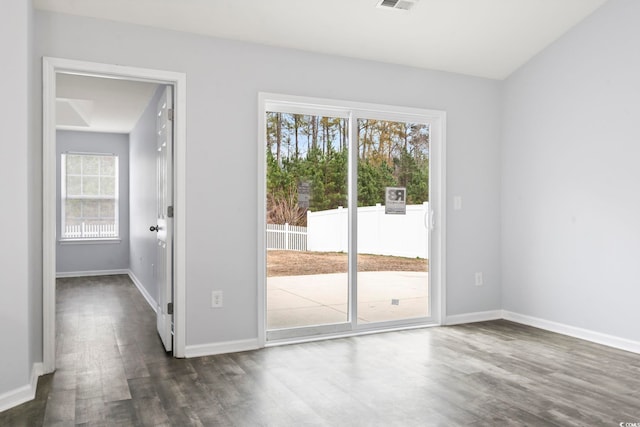 unfurnished room with dark wood-type flooring