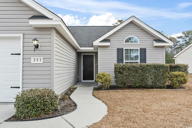 doorway to property featuring a garage