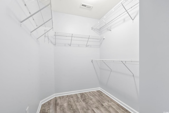 spacious closet with hardwood / wood-style floors