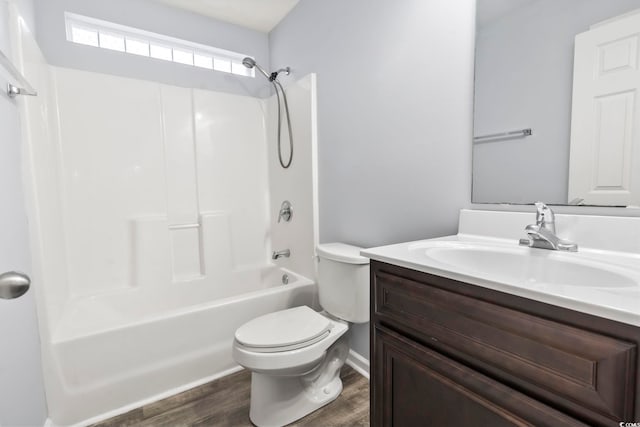 full bathroom featuring vanity, hardwood / wood-style floors, bathtub / shower combination, and toilet