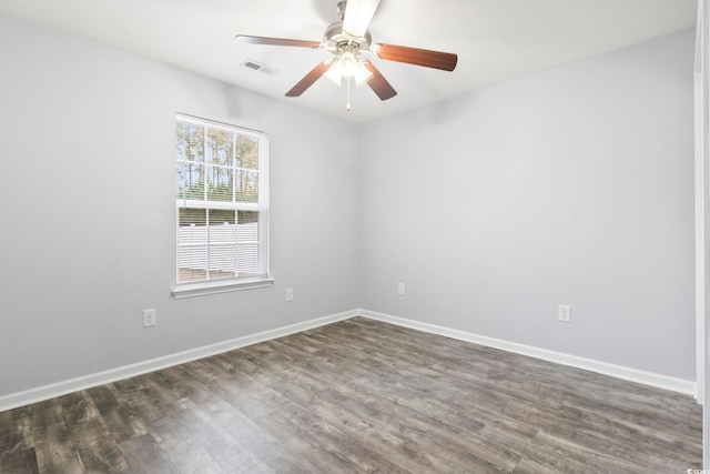 unfurnished room featuring dark wood-type flooring and ceiling fan