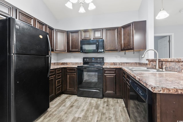 kitchen featuring sink, hanging light fixtures, dark brown cabinetry, black appliances, and light wood-type flooring