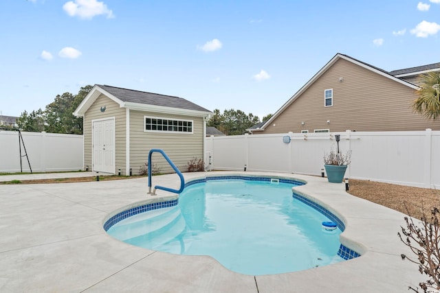 view of swimming pool with a patio and an outdoor structure