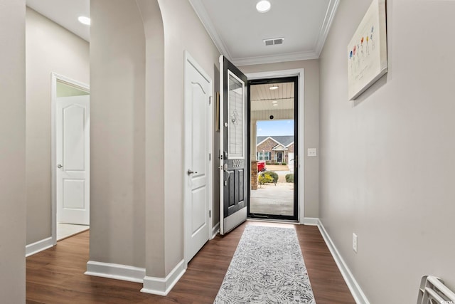 doorway featuring ornamental molding and dark hardwood / wood-style flooring