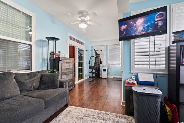 living room with ceiling fan and dark hardwood / wood-style floors