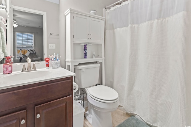 bathroom featuring toilet, ceiling fan, and vanity