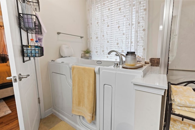 laundry room featuring light wood-type flooring