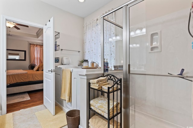 bathroom with walk in shower, ceiling fan, crown molding, and tile patterned flooring