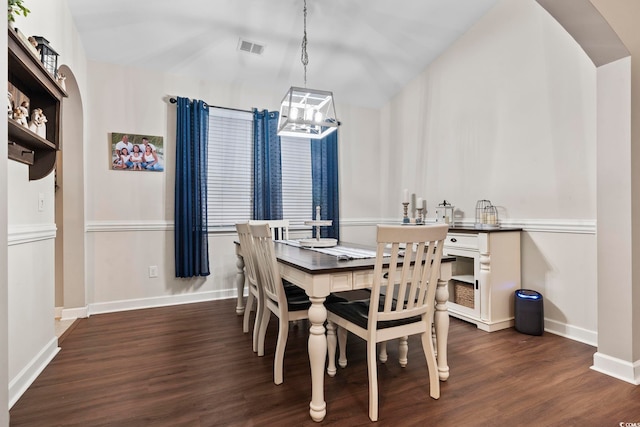 dining room featuring a notable chandelier and dark hardwood / wood-style flooring