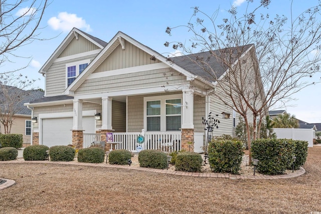 craftsman-style home featuring a porch, a garage, and a front lawn