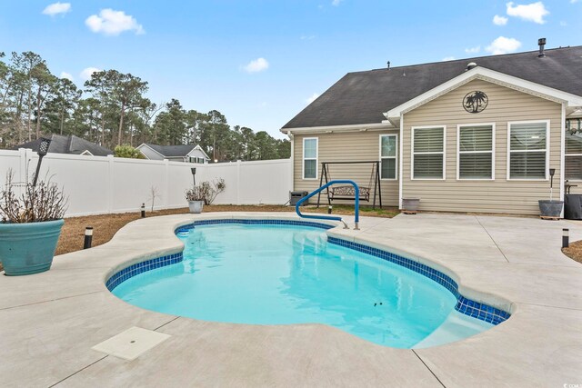 view of swimming pool featuring a patio area