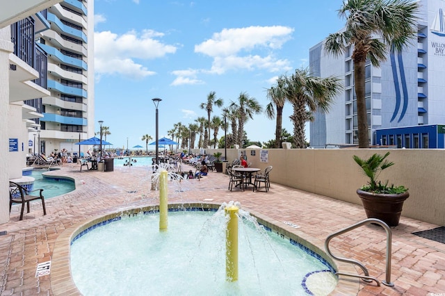 view of swimming pool with a patio and a water view