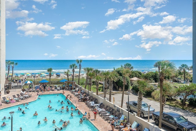 view of swimming pool with a water view and a patio