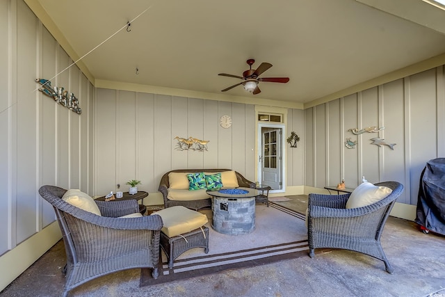 view of patio featuring ceiling fan and a fire pit