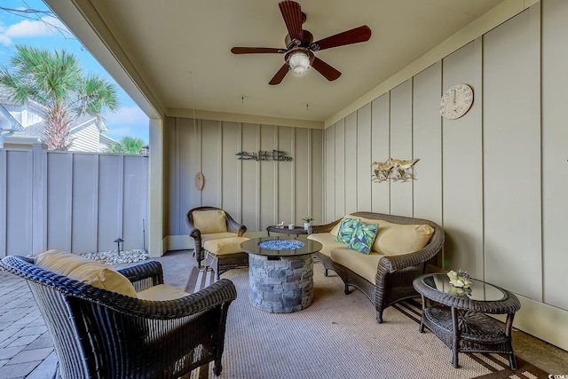 exterior space featuring a patio area, an outdoor living space with a fire pit, and ceiling fan