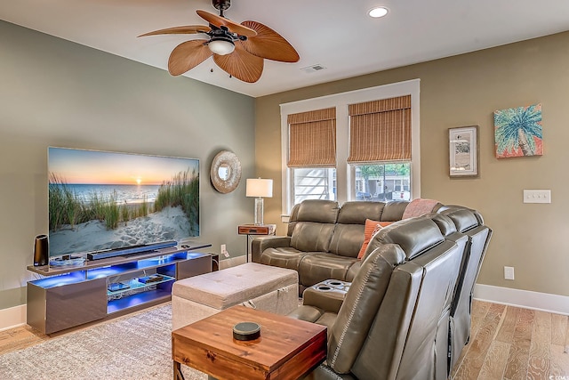 living room with light hardwood / wood-style flooring and ceiling fan