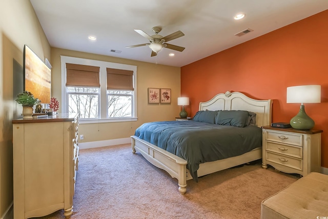 bedroom featuring light colored carpet and ceiling fan