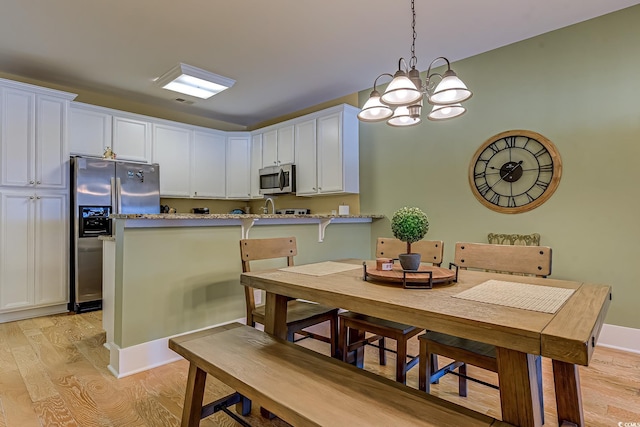 dining area with light wood-type flooring