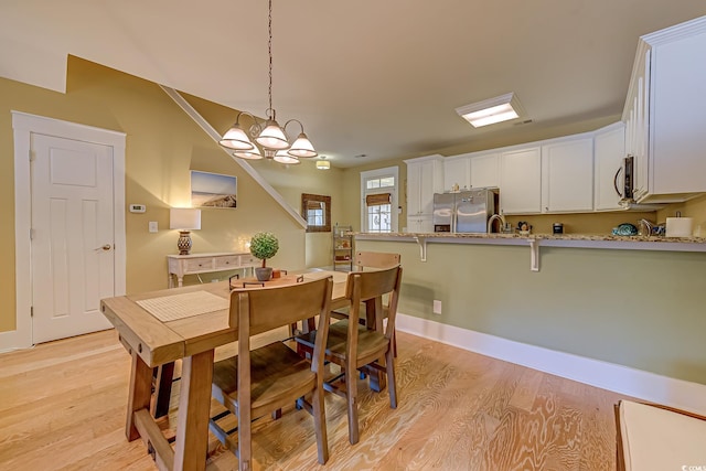 dining space featuring a chandelier and light hardwood / wood-style floors