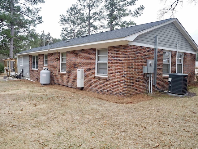 rear view of property with a yard and cooling unit