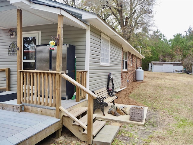 exterior space with a shed, a wooden deck, and a lawn