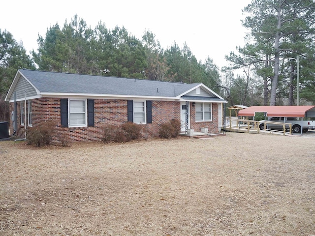 ranch-style house with a carport and central AC