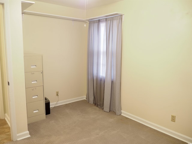 unfurnished room featuring light colored carpet